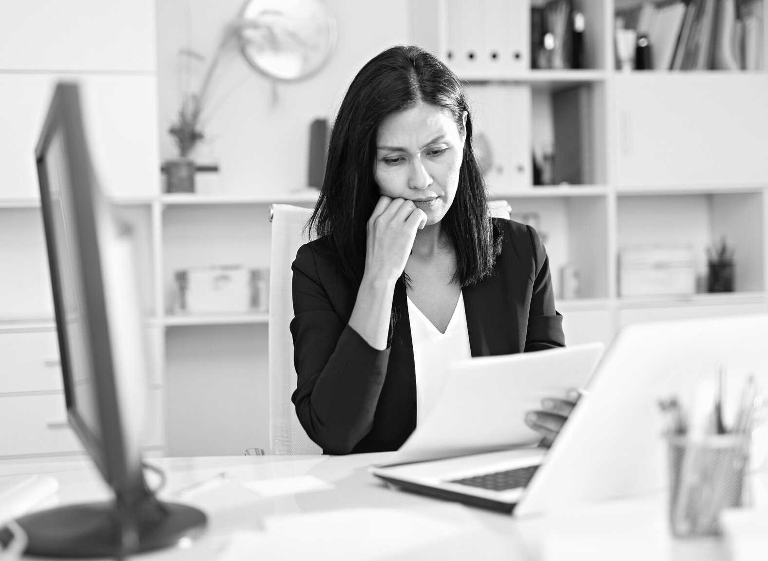 Worried young woman manager working with documents